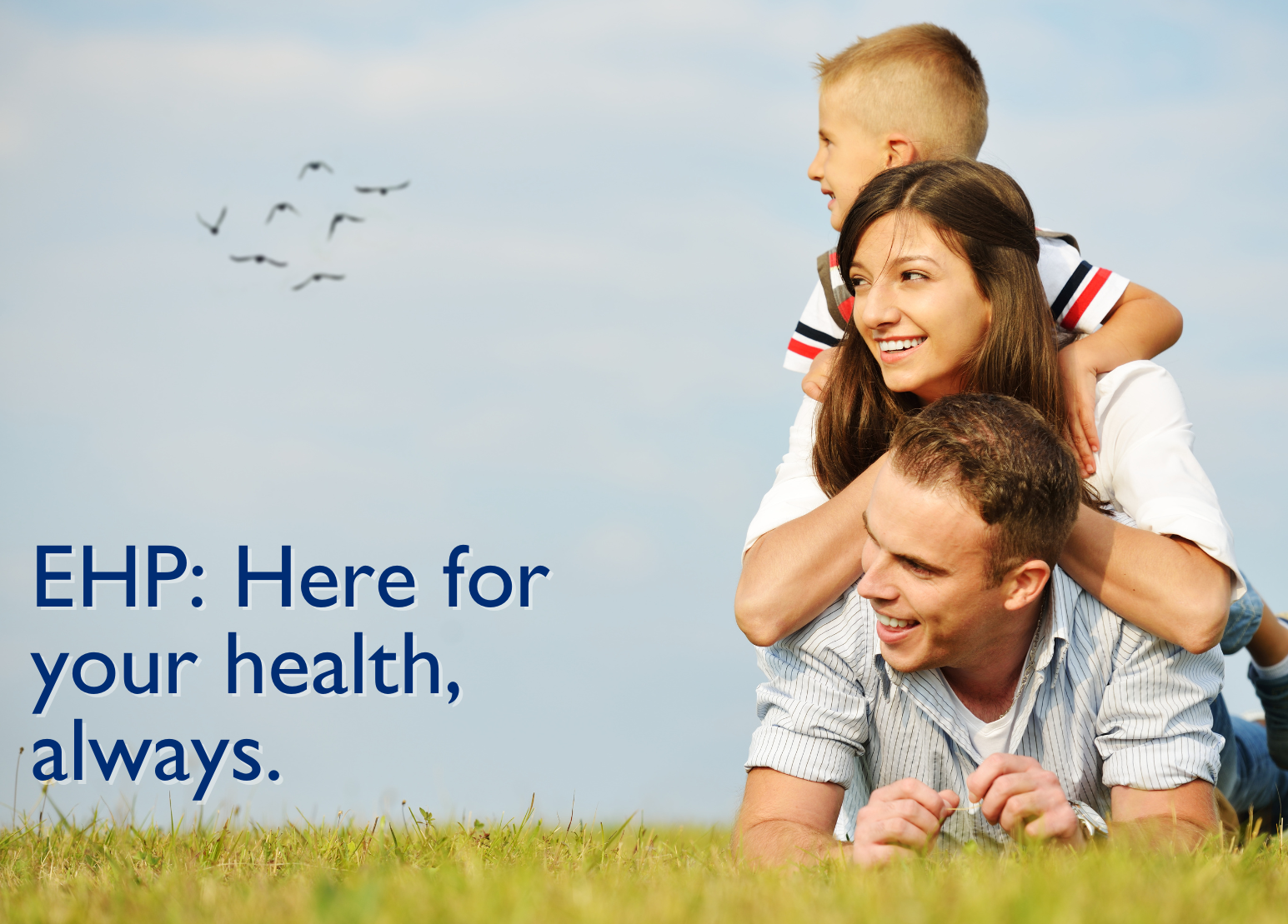 Smiling family outdoors, with a young child on the mother’s back, conveying health, happiness, and togetherness under a clear blue sky. Message: EHP is committed to supporting your health every step of the way.